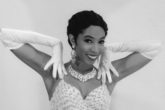 Black and white portrait of Aerie Williams in pearls and gloves